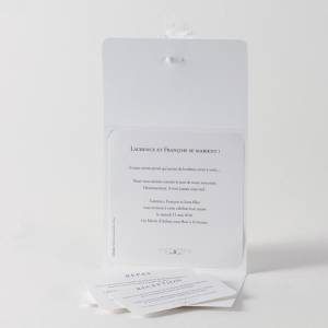 Faire-part blanc pour annoncer votre mariage. Ouvert, il laisse apparaitre les deux cartons d'invitation inclus.
